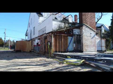 Ground level tracking shot of dilapidated hotel in the Hamptons
