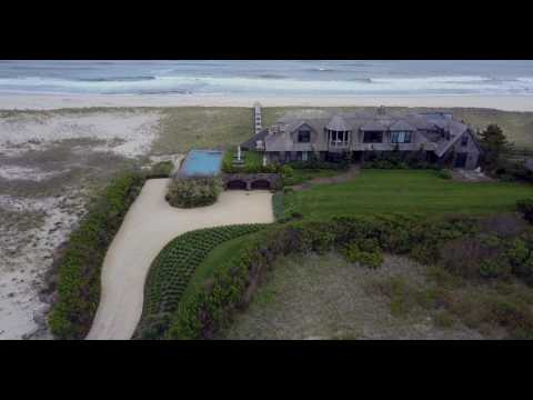 Aerial tracking shot of large oceanfront Hamptons estate