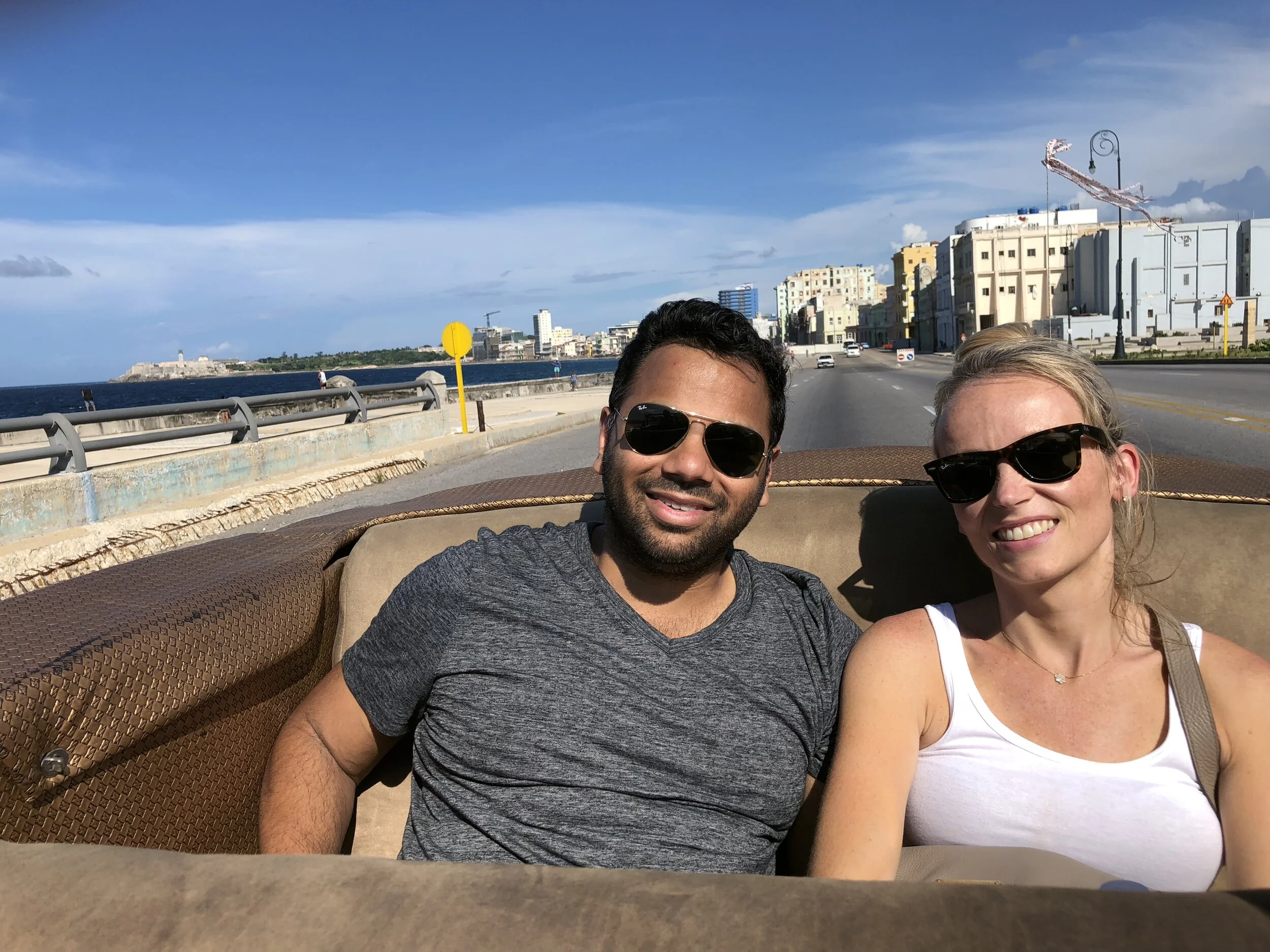 Vinod and his wife enjoying a ride on the Malécon in a vintage car.