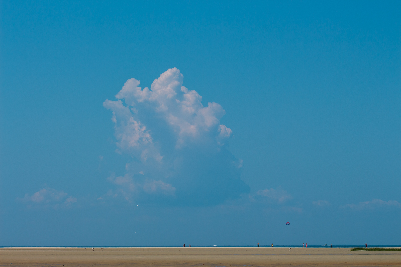A lone cloud in the crystal blue sky