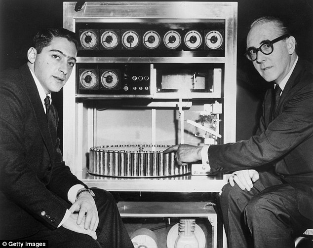 US film producer Mike Todd Jr (left) sits in 1959 with Swiss inventor Hans Laube (right), who points to his Smell-O-vision machine, which made smells in synchronization with action in the film Scent of Mystery