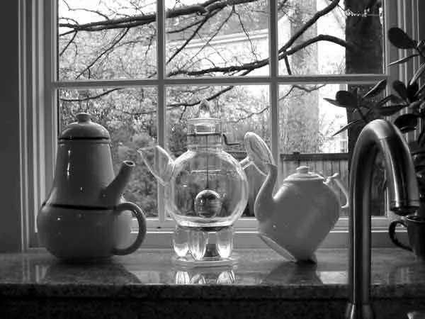 Three teapots: works of art in the window above the kitchen sink. Donald Norman's collection. 