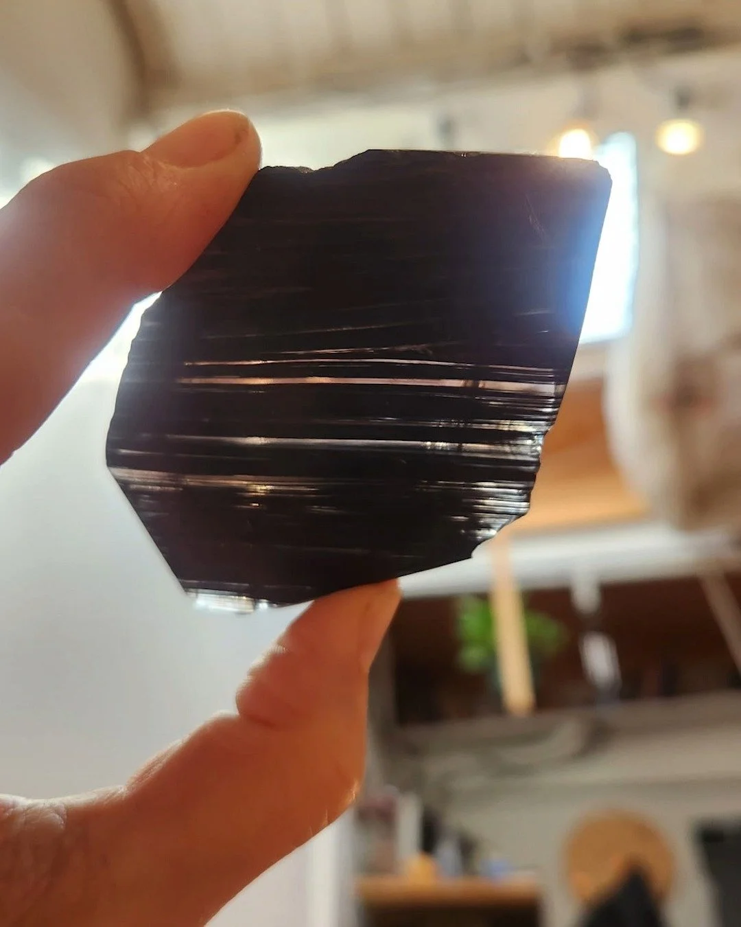 Thayer @thayerworks in the process of carving an #Obsidian amulet. She also made a couple other pieces. The smaller carving is in transparent Alabaster, and a Marble piece we drilled to hold lighting.