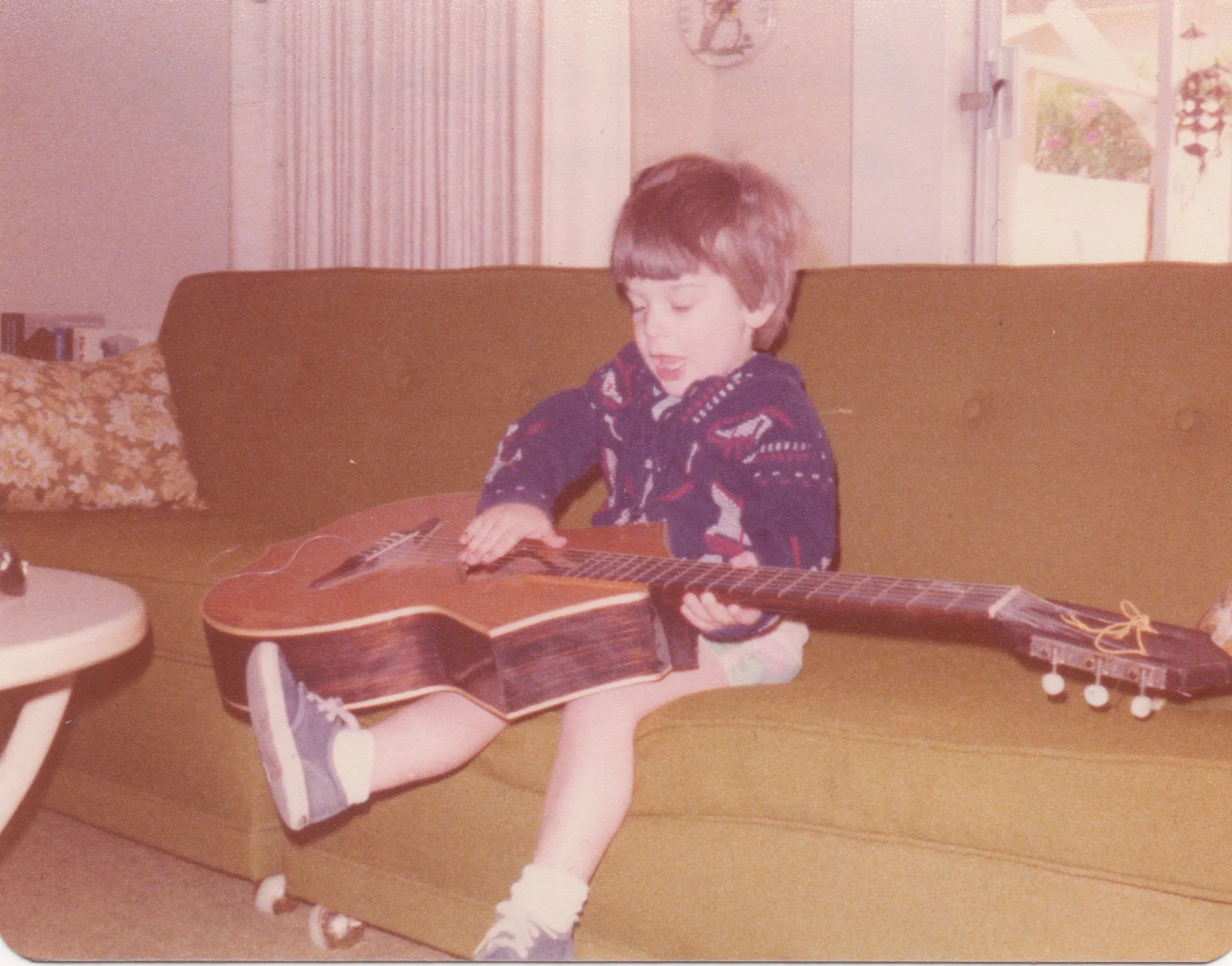 1977 - Palm Springs, CA. My grandmother must have had this guitar in her house, and at age 2 this is probably the first time I ever touched one.