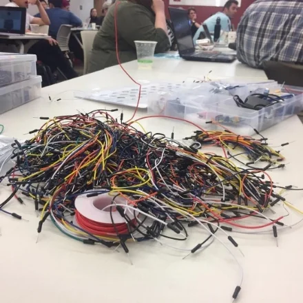 A pile of multi-colored Arduino wires on a classroom table.