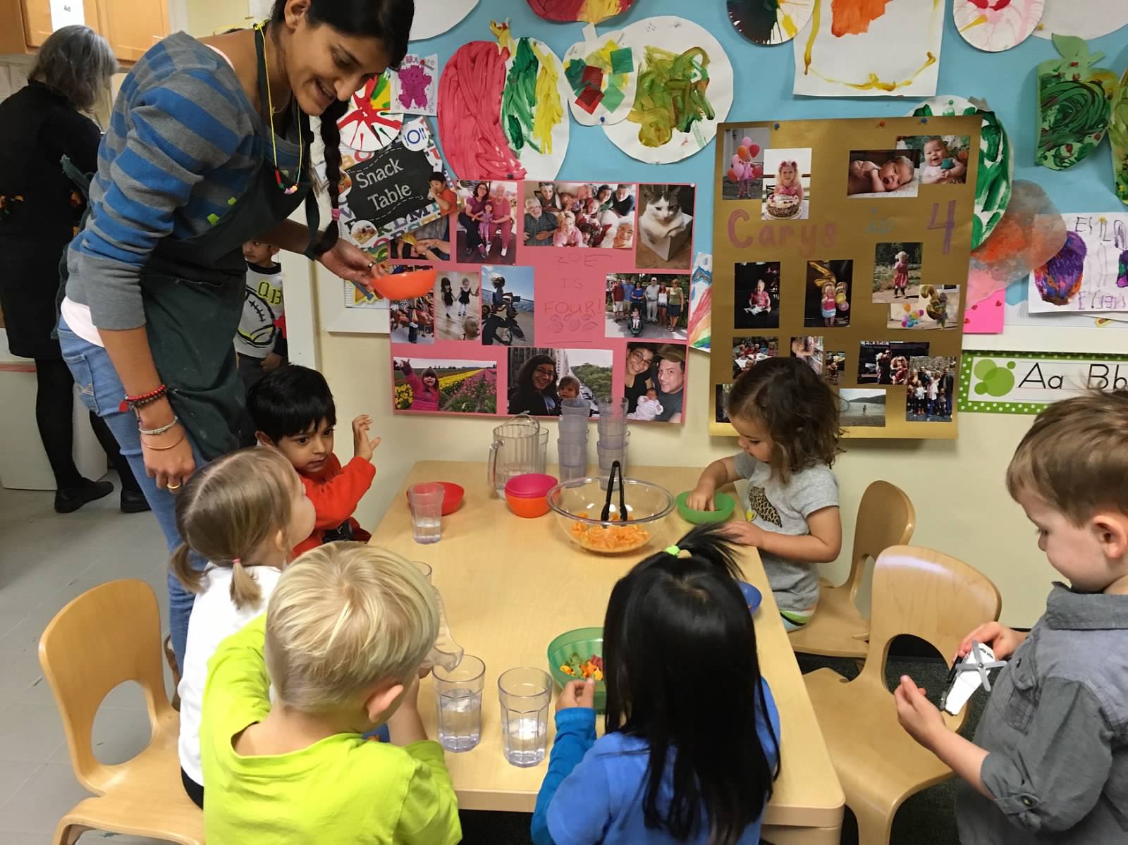 During snack, the children sit together, serve themselves, and clean up afterwards. 