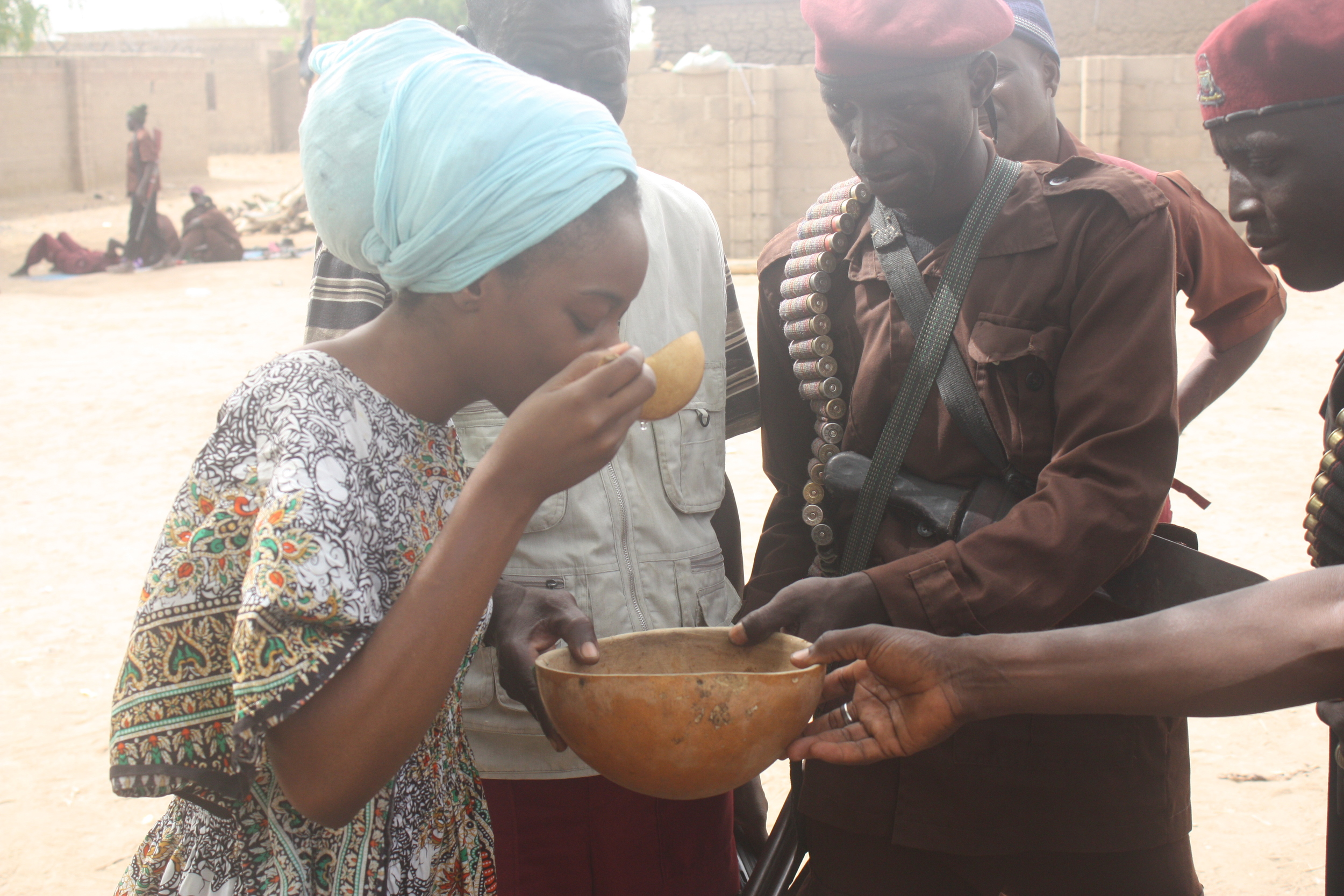 I was hanging out with these guys who are members of a vigilante fighter group. They're protecting their community of Chibok (that's the town in northeastern Nigeria where almost 300 schoolgirls were kidnapped by Boko Haram in April 2014) against Boko Haram. They're getting ready to go out into the field and they drink this potion to give them spiritual power. They gave me a sip so I can tap into some of that power as well. It tasted like.... water. 