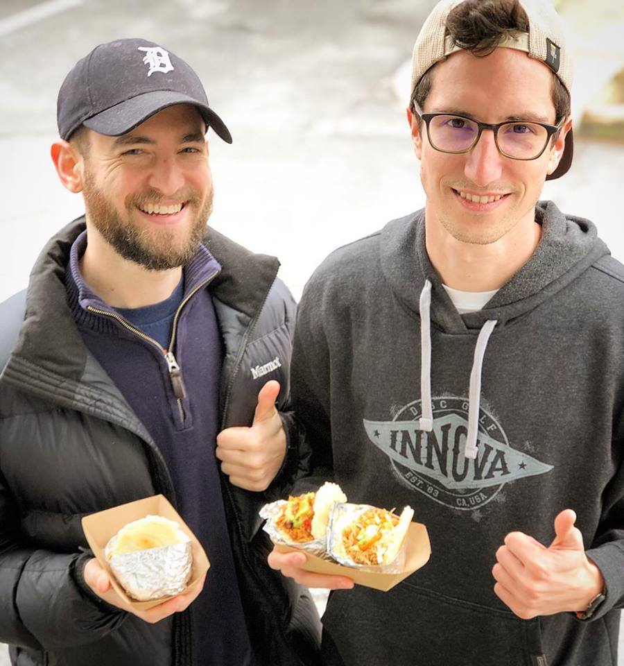 two guys with arepas.jpg