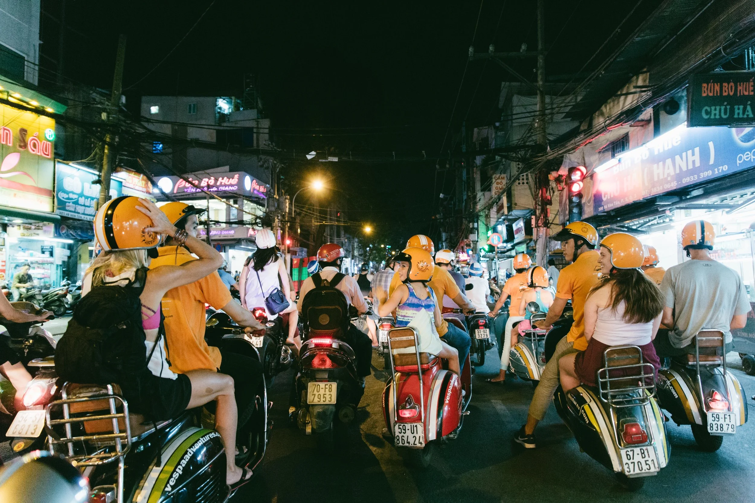 What better way to take in the sights, sounds, and feel of a new city then to hop the back of 6 scooters for a tour of Saigon after dark. In a city with over 10 million people and 8 million scooters, it is pretty much the only option to get around. We spent the evening trying local street food, seeing famous landmarks, and laughing constantly as we zigged and zagged all over the city. At this red light, we share a laugh, tighten our helmets and do a quick head count to make sure we have everyone! 
