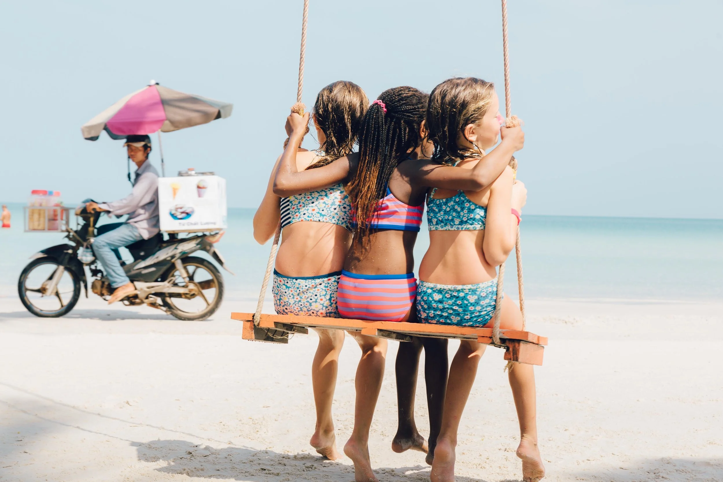 Enjoying the slow pace of island life on Phu Quoc Island, Vietnam. The white sand and turquoise waters of Sao Beach, were one of our favorite places to spend our days on this journey. The girls got plenty of use out of this fun swing, and this photo captures the ice cream man going by on scooter at the perfect time! 