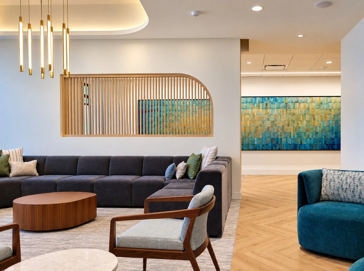 Custom commissioned hand-dyed aluminum wall art featuring blue, teal, and gold tones in a contemporary lounge at Houston Methodist's award-winning HEAL Wellness Center.