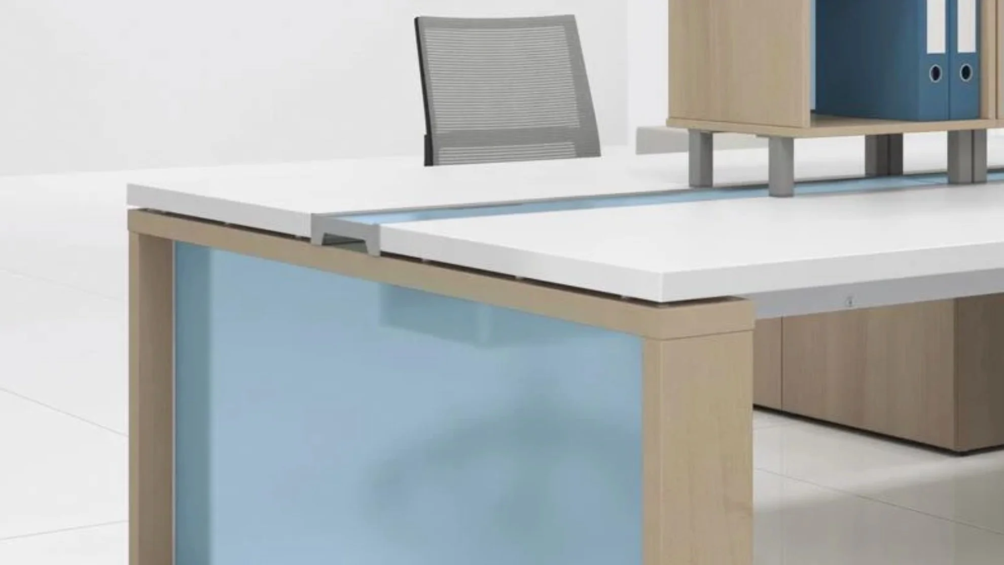 Contemporary office workstation featuring custom blue privacy panels, light wood finishes, a white work surface, and integrated desktop storage.