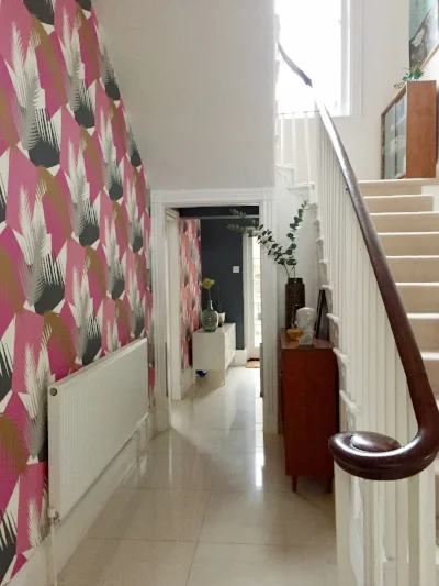 View to the rear hallway. Ignore truly shocking stair carpet.