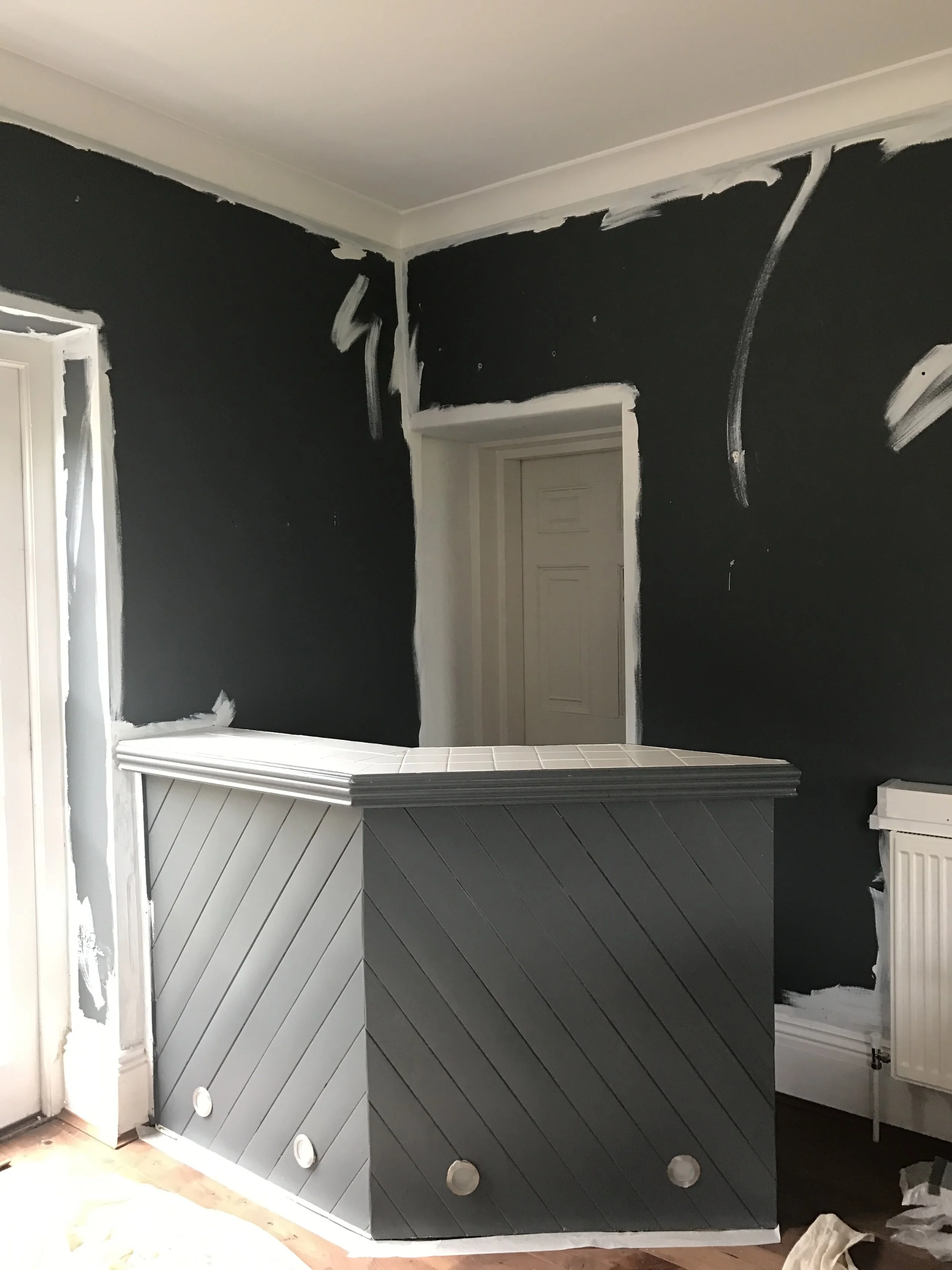 The before shot. Do a quick white paint edge to your walls top and bottom before you start if you have a dark wall.