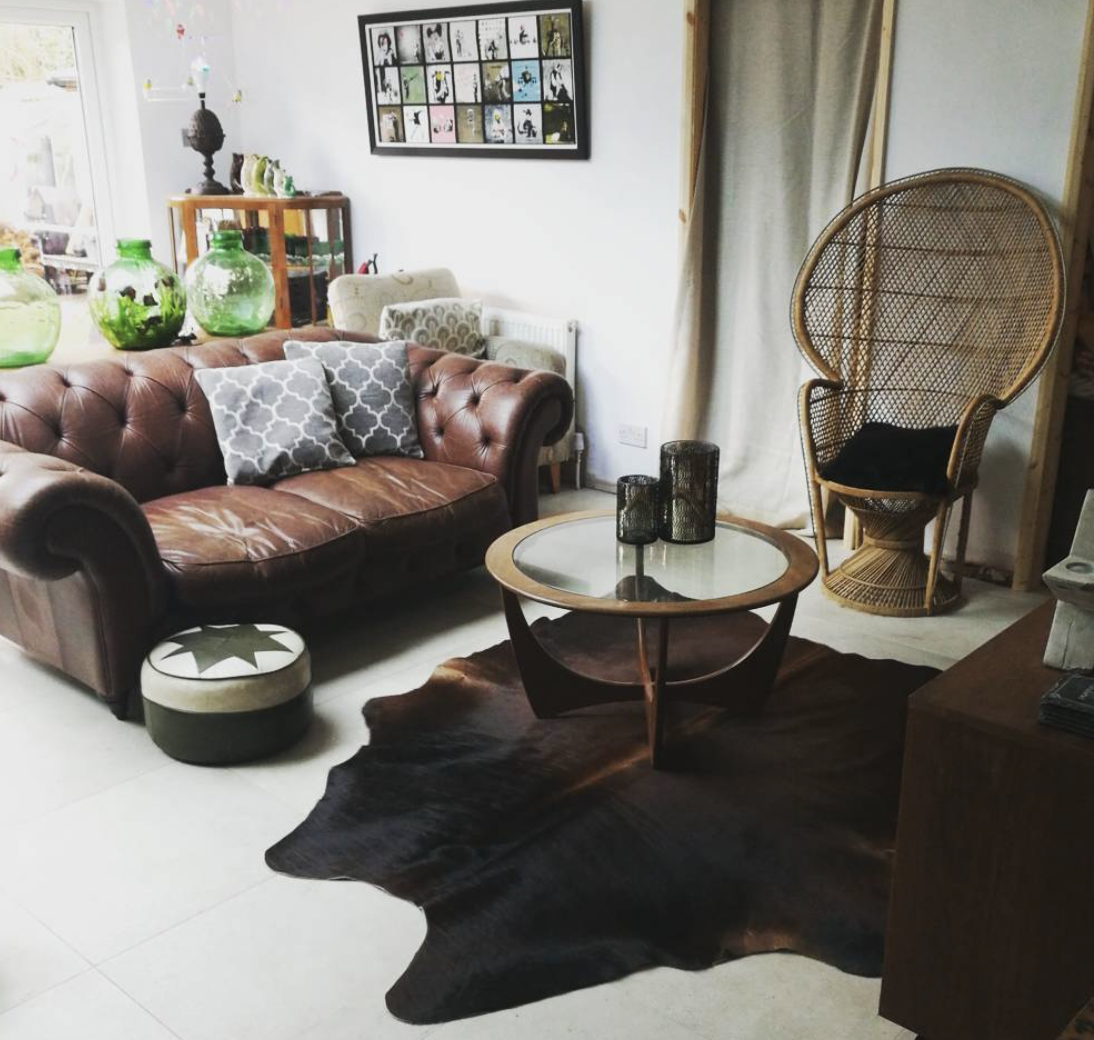 Karen Watson 's living room is nearly all charity and thrift purchases, including the three carboys at the back.