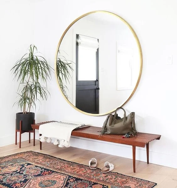 The perfect lobby mirror. Photo and design credit: Amber Interiors