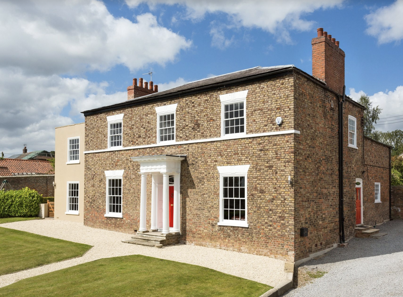 The official Estate Agency photograph of our home. If only the grass looked like this now.