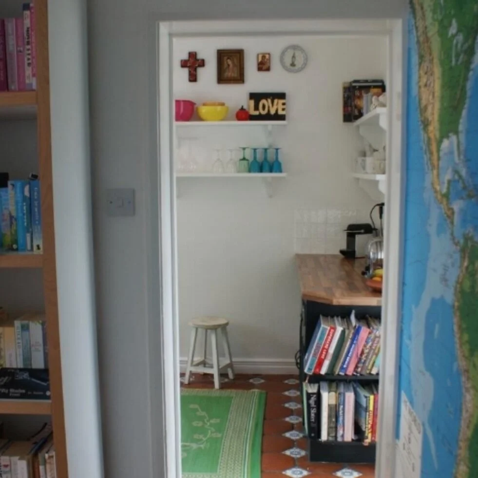 The tiny kitchen in our Caversham house. I painted the walls, tiles, cupboards, took down the shelves and replaced the worktop with wood effect MDF.