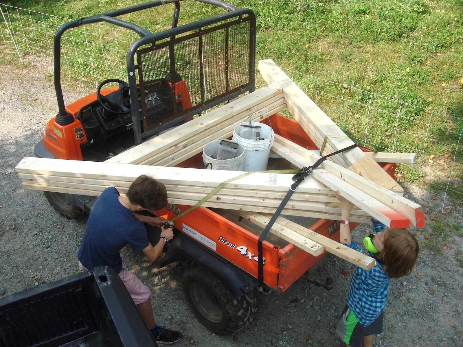 Hale and Ripley ensure that all of our materials are strapped down and secure before driving up to the worksite.