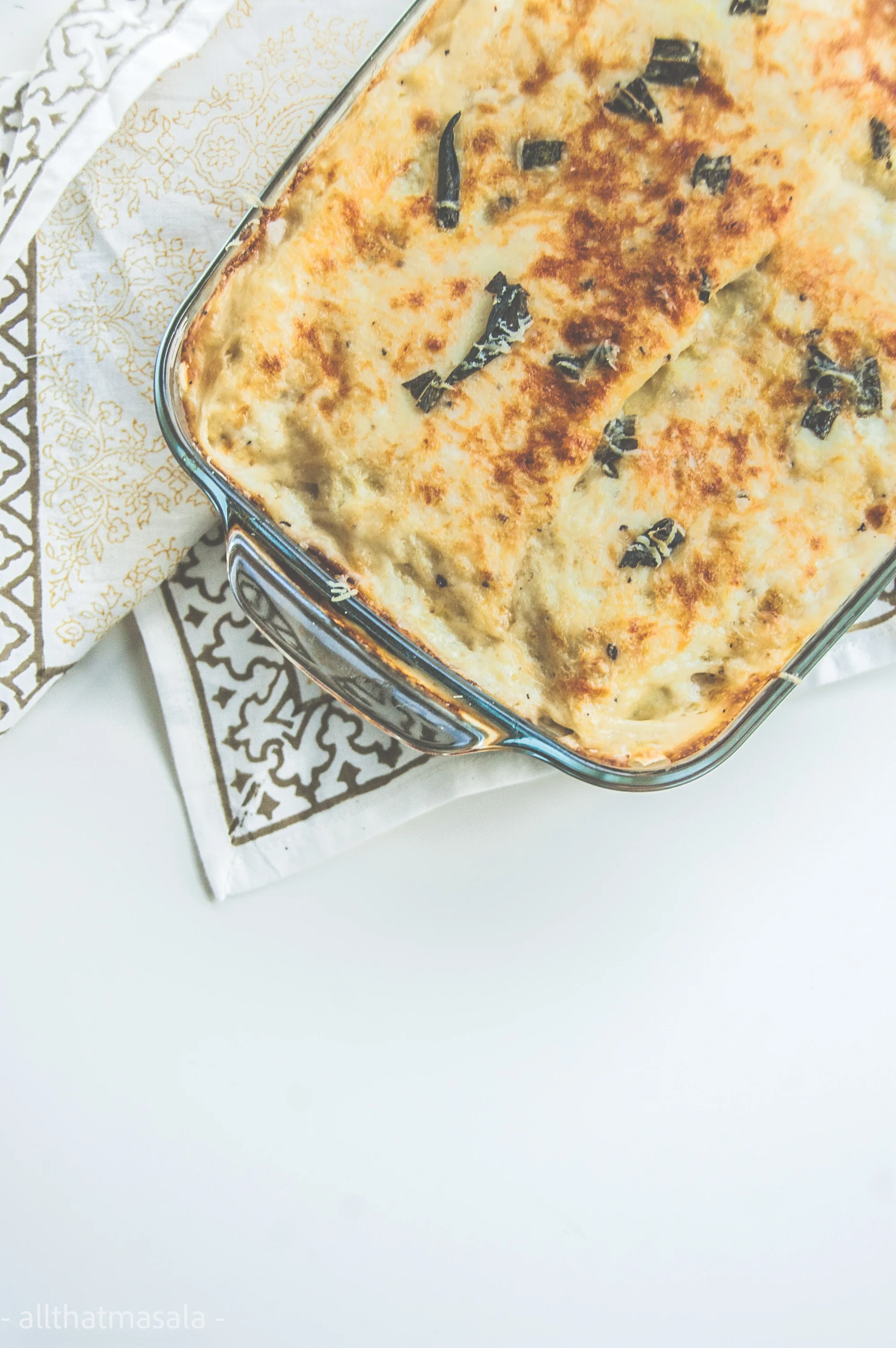 Pumpkin kale lasagna makes a warm pot of autumn dinner delight. This vegetarian lasagna recipe is made with baked cinderella pumpkin, stir fried kale, and warm gooey bechamel sauce.