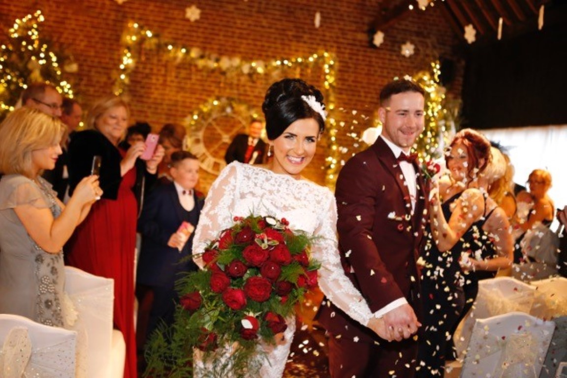 Bride and Groom exiting the fathom barn