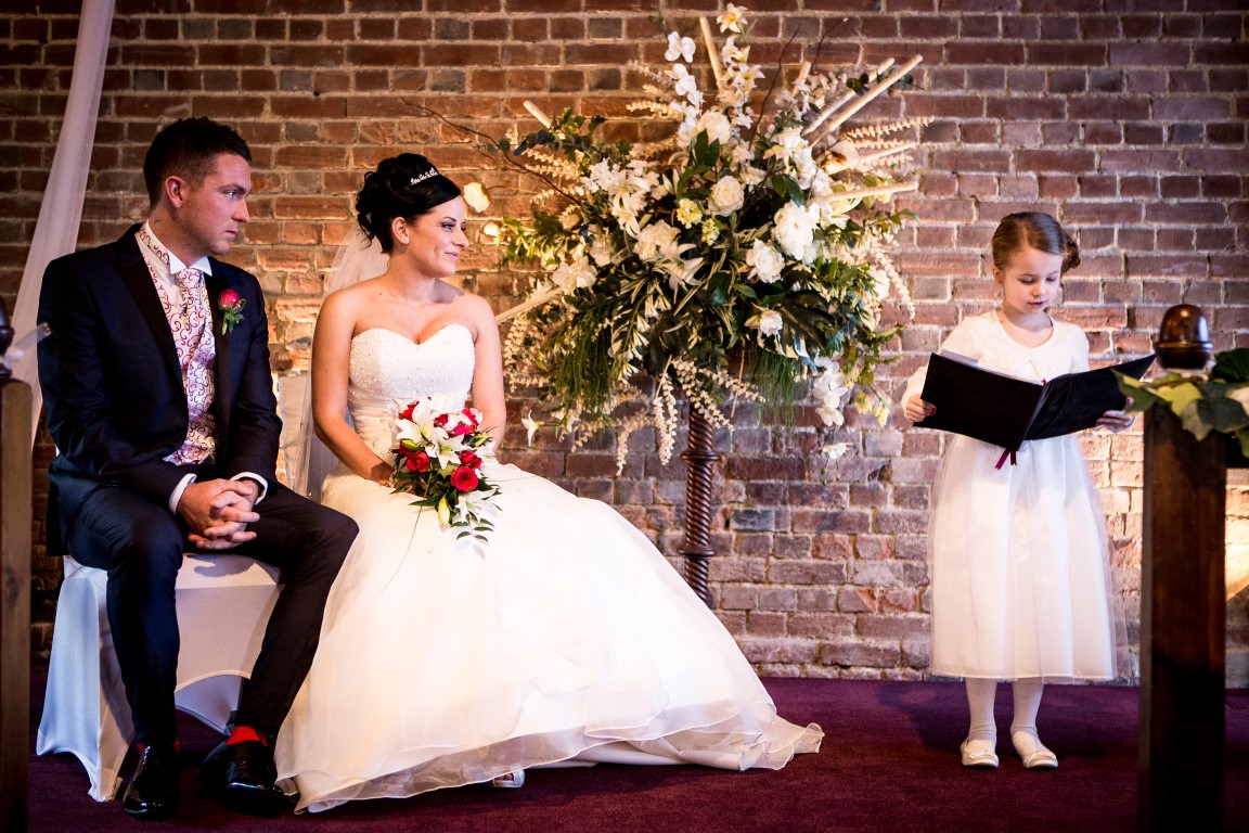 Little girl doing a reading during a wedding ceremony
