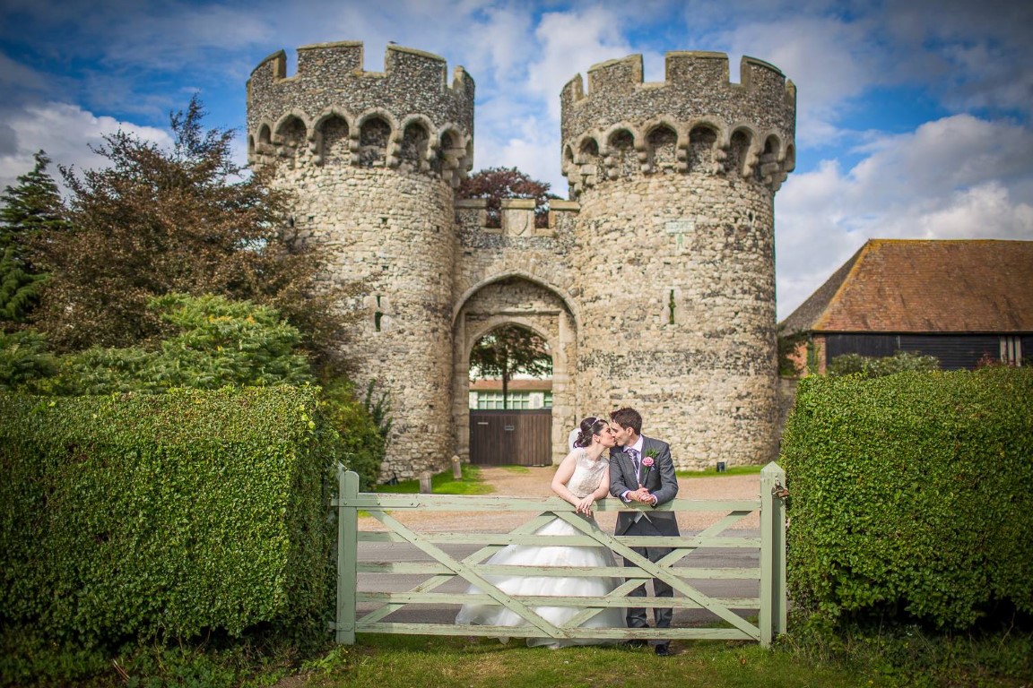 Bride and groom kissing at the gate