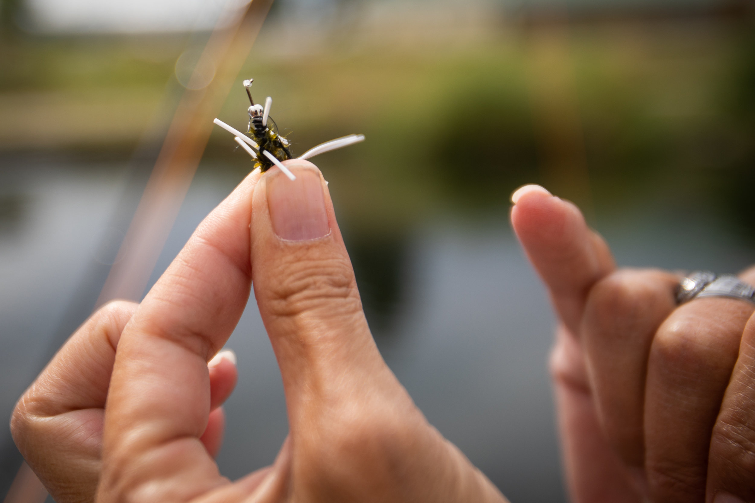  Verlicia Perez, lead mentor for The Utah Mayfly Project, points out details on a fly pattern to foster care children while fly fishing at a trout pond on Saturday, July 14, 2018, in Smithfield. The Mayfly Project is a national non-profit that uses f