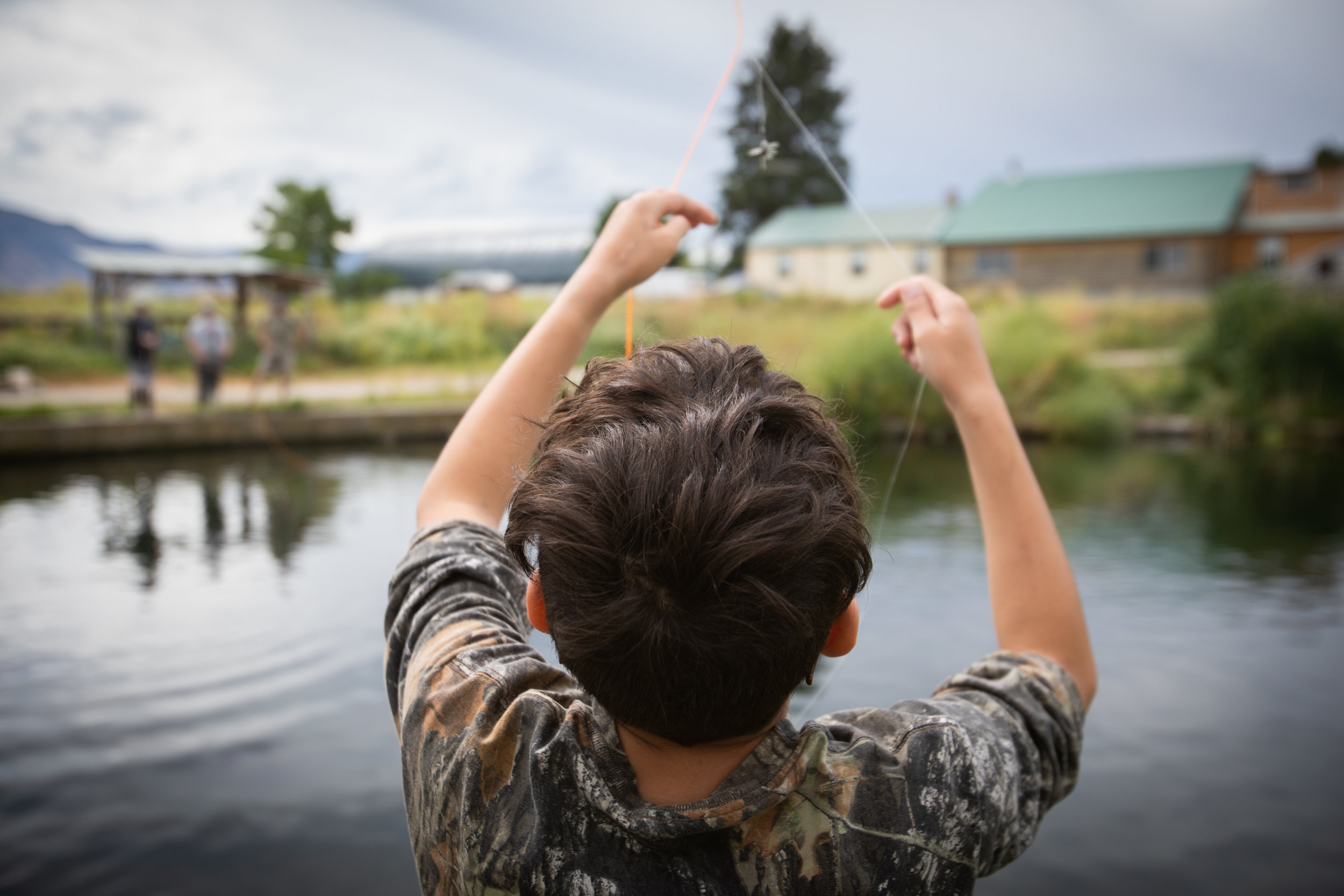  Utah foster care children fly fish on a trout pond on Saturday, July 14, 2018, in Smithfield. The outing was one of several this summer that was part of The Mayfly Project, a national non-profit that uses fly fishing to mentor foster care children. 