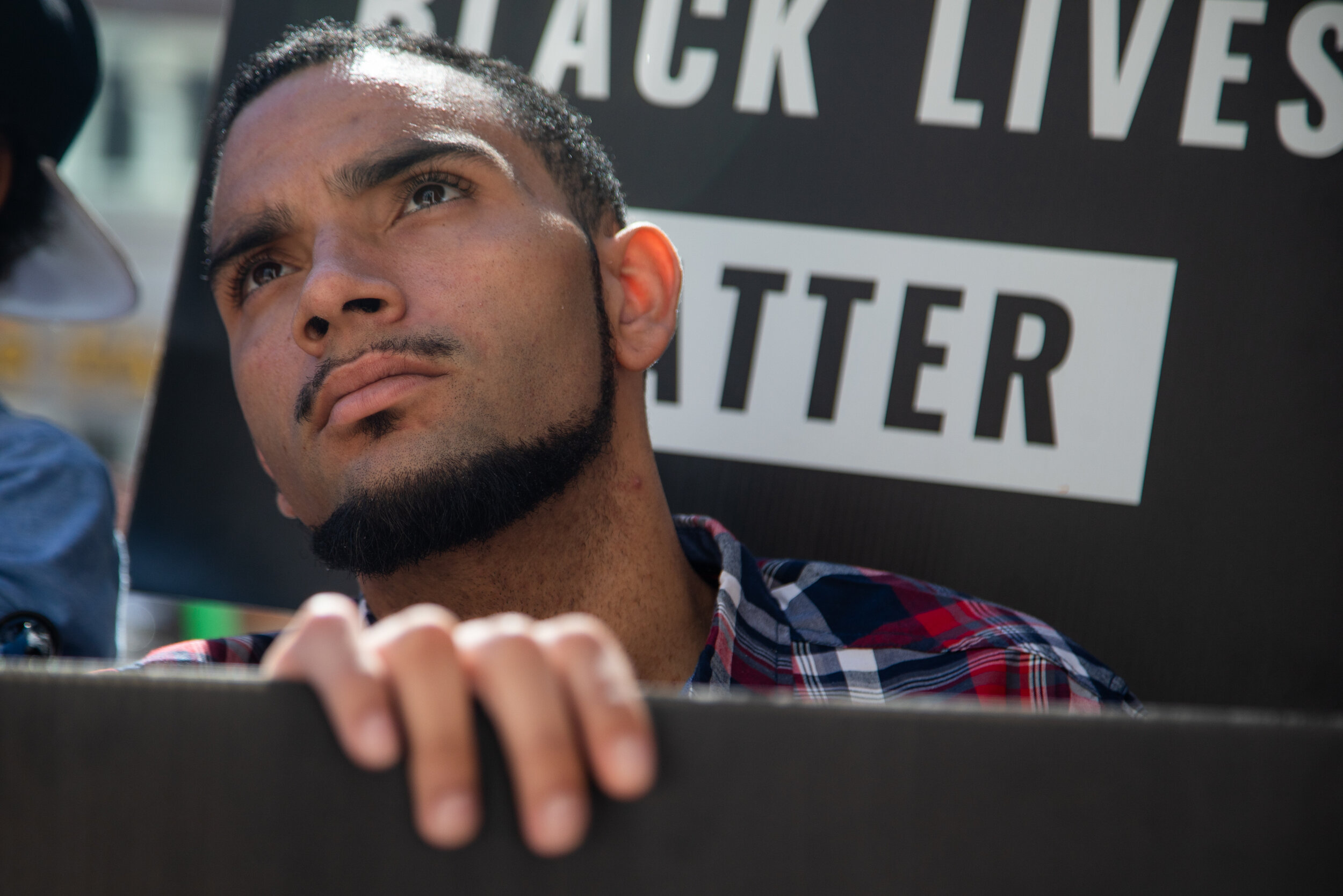  Jamal Bell gazes up at the windows of the Weber County Attorney's Office on Friday, June 21, 2019. Community members and the Black Lives Matter group gathered to protest his confrontation with police in March. 