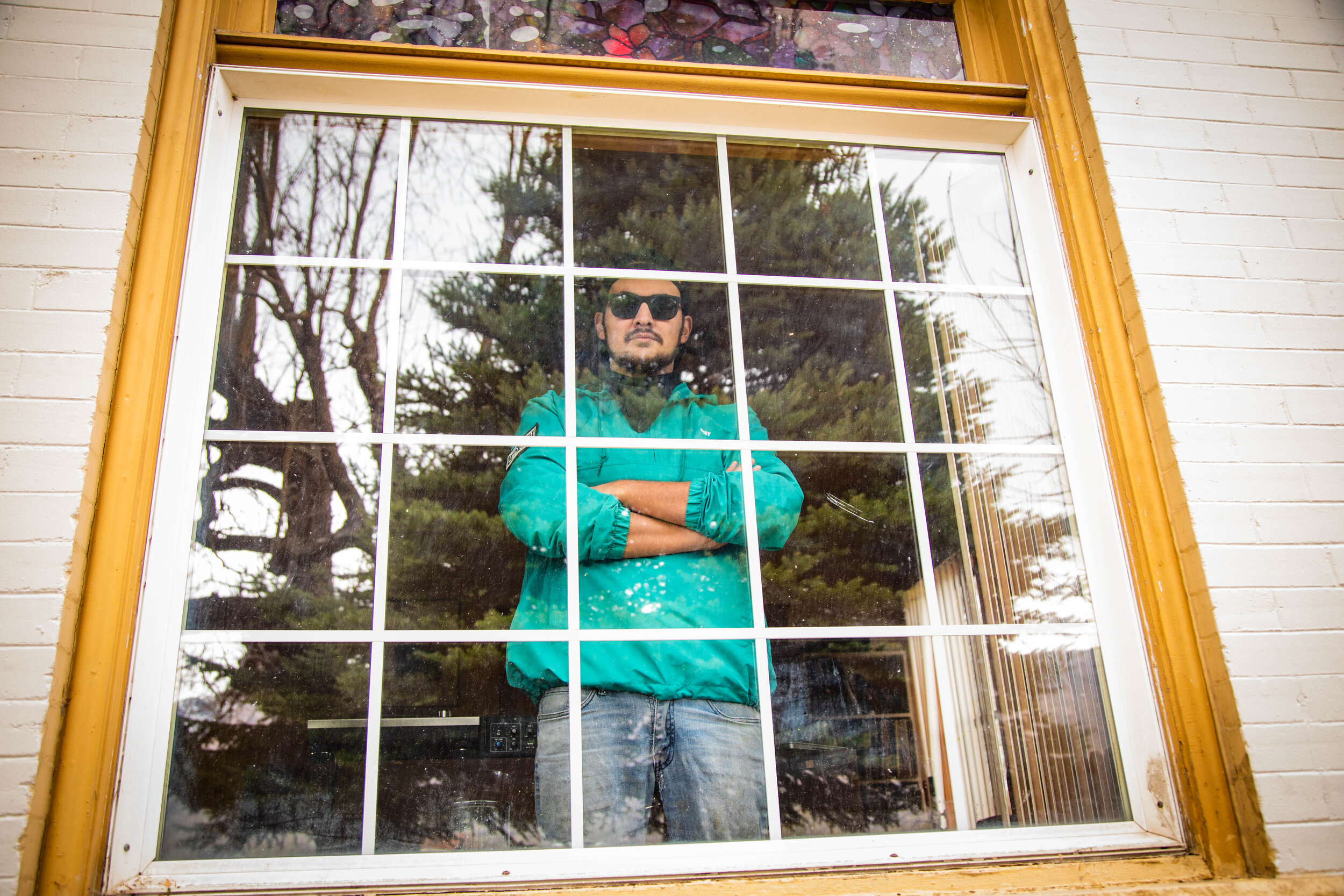  COVID-19 survivor Antonio Cruz Martinez poses for a portrait through his window on Monday, April 6, 2020, in Ogden. The 32-year-old DJ says he may have contracted the disease while playing a show in Park City in early March.   
