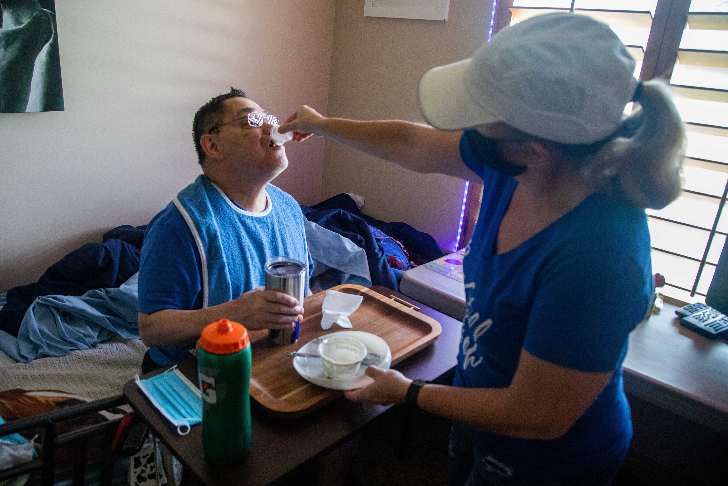  Ron Vigil, left, takes his morning medication dose from his cousin Denise Vigil-Thieldfoldt on Friday, May 22, 2020, in Syracuse, Utah. 