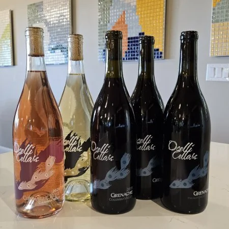 Five bottles of 100% Grenache wine from Ocelli Cellars displayed with local artist tile art, Dundee, Oregon winery in Willamette Valley