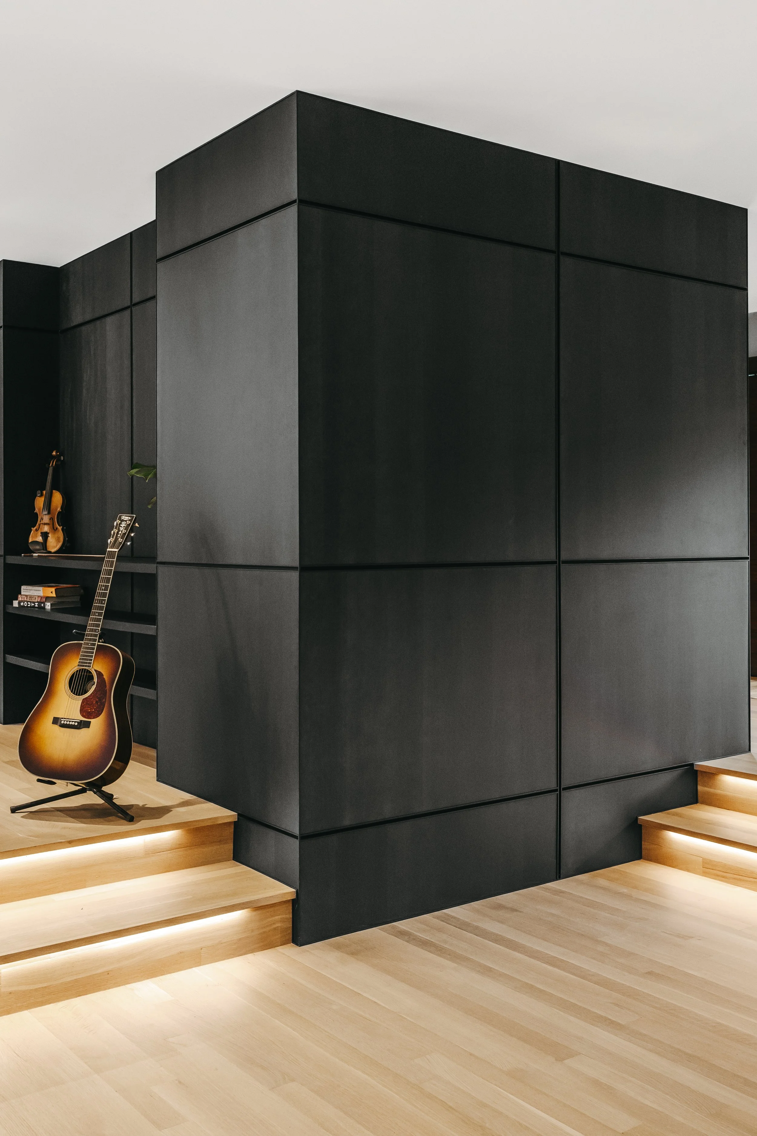 Custom woodwork by Sunnyside Millwork Black rift white oak panel wall with India ink finish and Fry Reglet aluminum reveals creating clean architectural wall transitions in Kernersville, North Carolina integrated flush seams, custom architectural mil