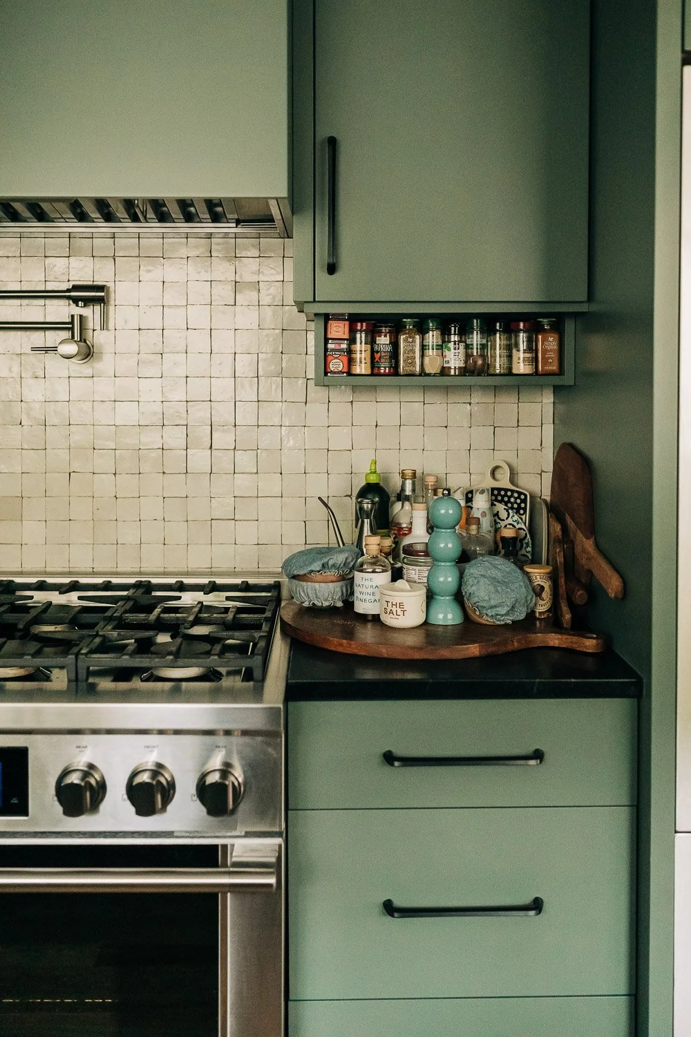 Tile and material transition detail showing backsplash, wood cabinetry, and finish coordination in mountain kitchen remodel