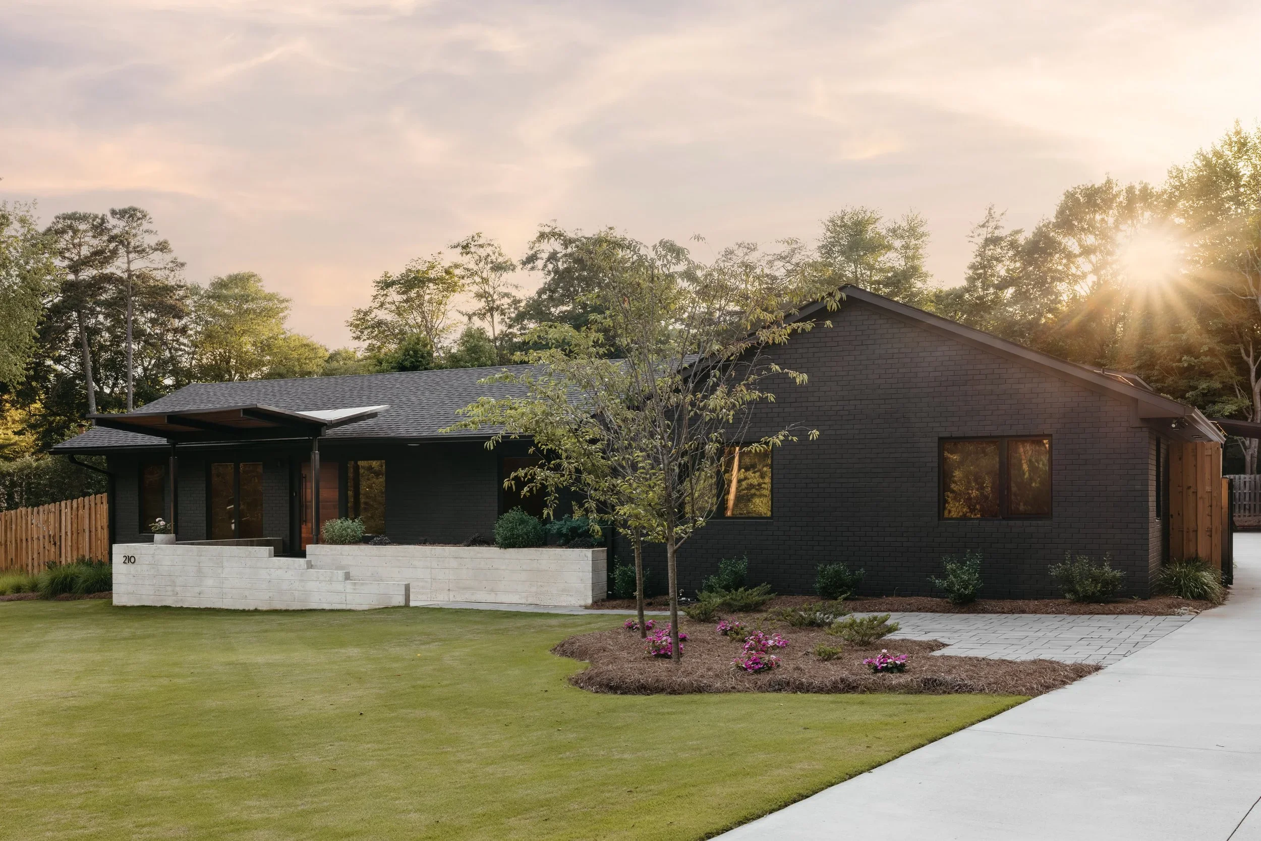 Remodeled ranch home exterior in downtown Kernersville North Carolina with modern siding, landscape design, and updated residential architecture