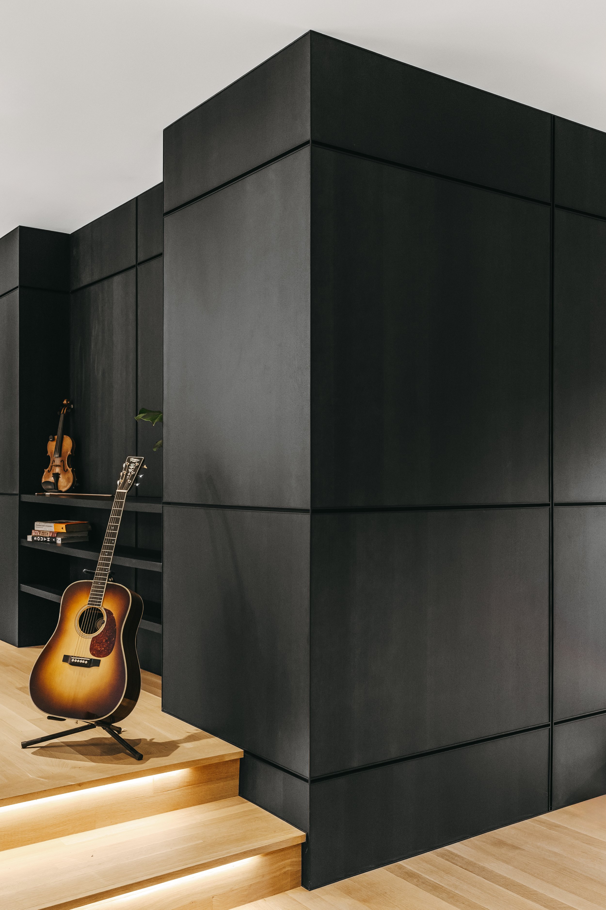 Custom woodwork by Sunnyside Millwork Black rift white oak panel wall with India ink finish and Fry Reglet aluminum reveals creating clean architectural wall transitions in Kernersville, North Carolina integrated flush seams, custom architectural mil