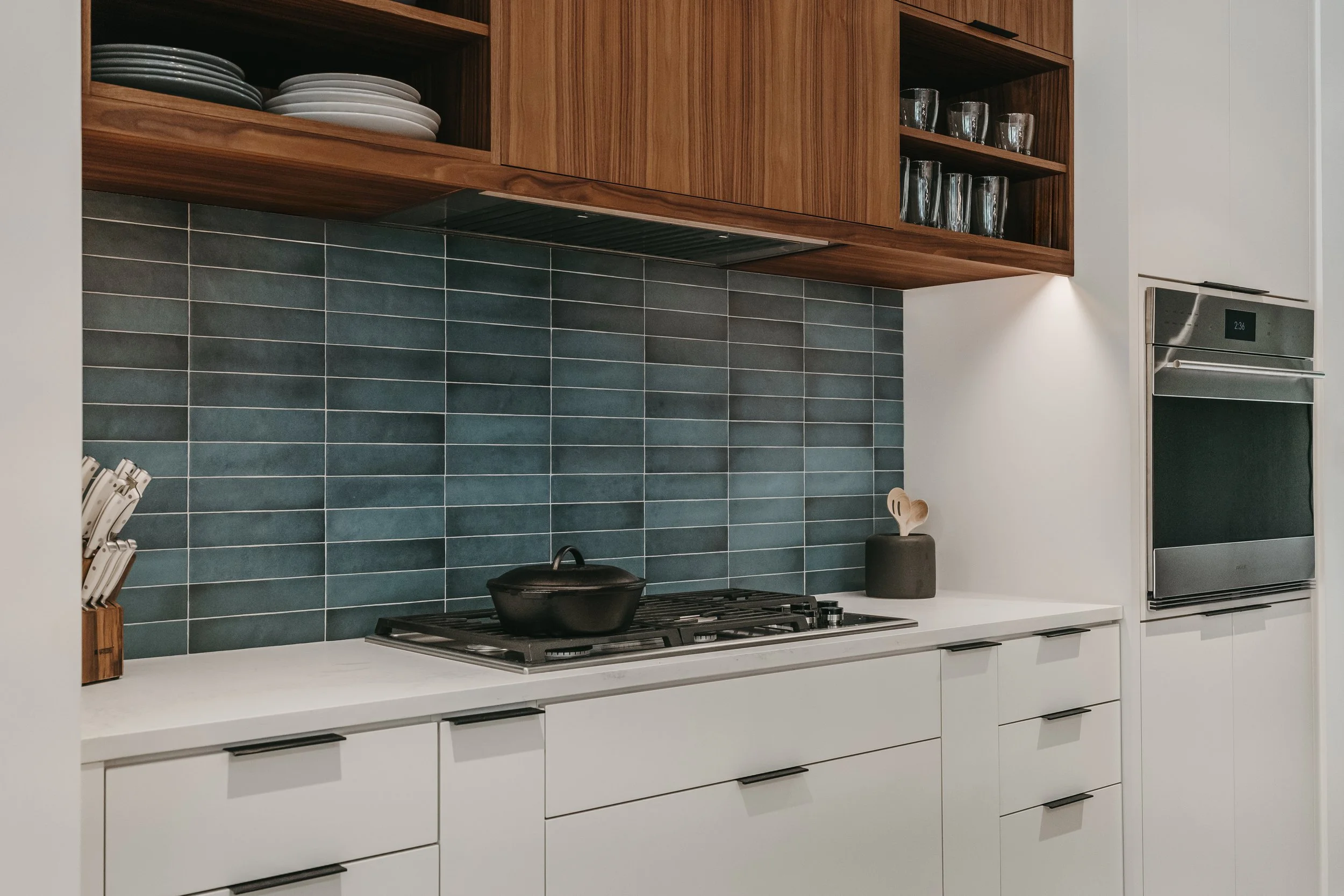 Custom woodwork by Sunnyside Millwork Open concept Two-tone kitchen with grain-matched walnut uppers, white lacquer cabinets, and integrated millwork island with quartz surface in Kernersville, North Carolina