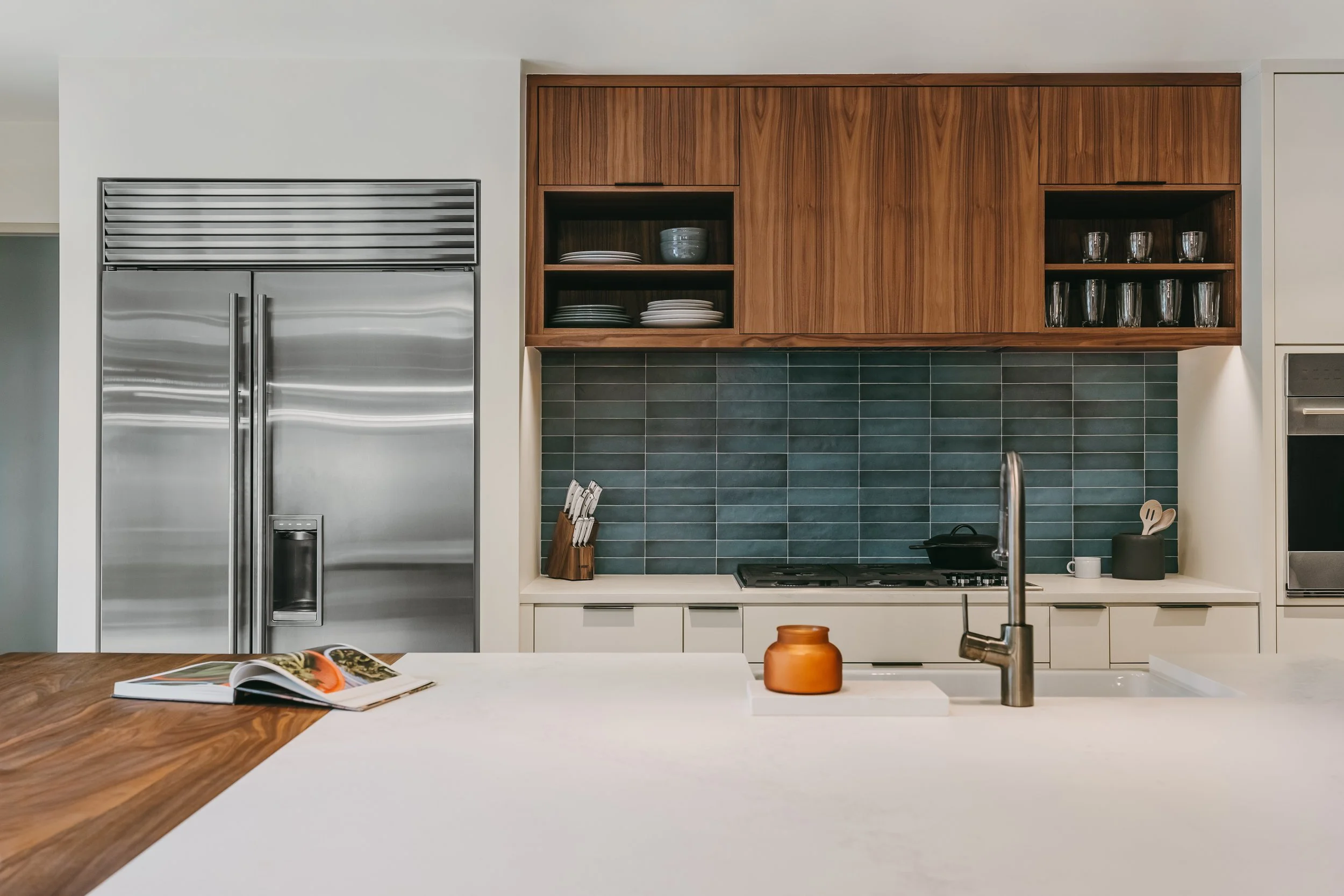 Custom woodwork by Sunnyside Millwork Open concept Two-tone kitchen with grain-matched walnut uppers, white lacquer cabinets, and integrated millwork island with quartz surface in Kernersville, North Carolina