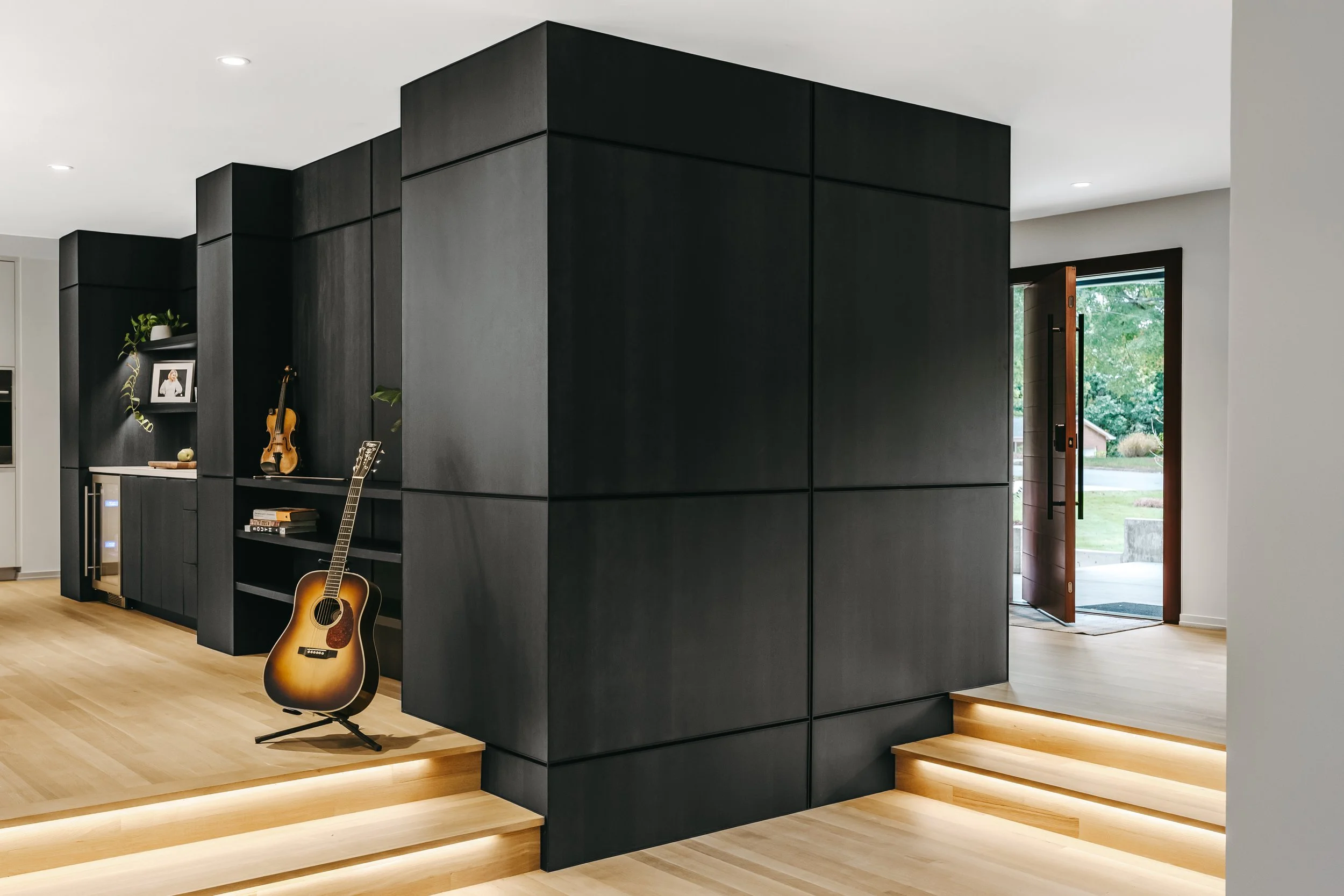 Custom woodwork by Sunnyside Millwork Black rift white oak panel wall with India ink finish and Fry Reglet aluminum reveals creating clean architectural wall transitions in Kernersville, North Carolina integrated flush seams, custom architectural mil