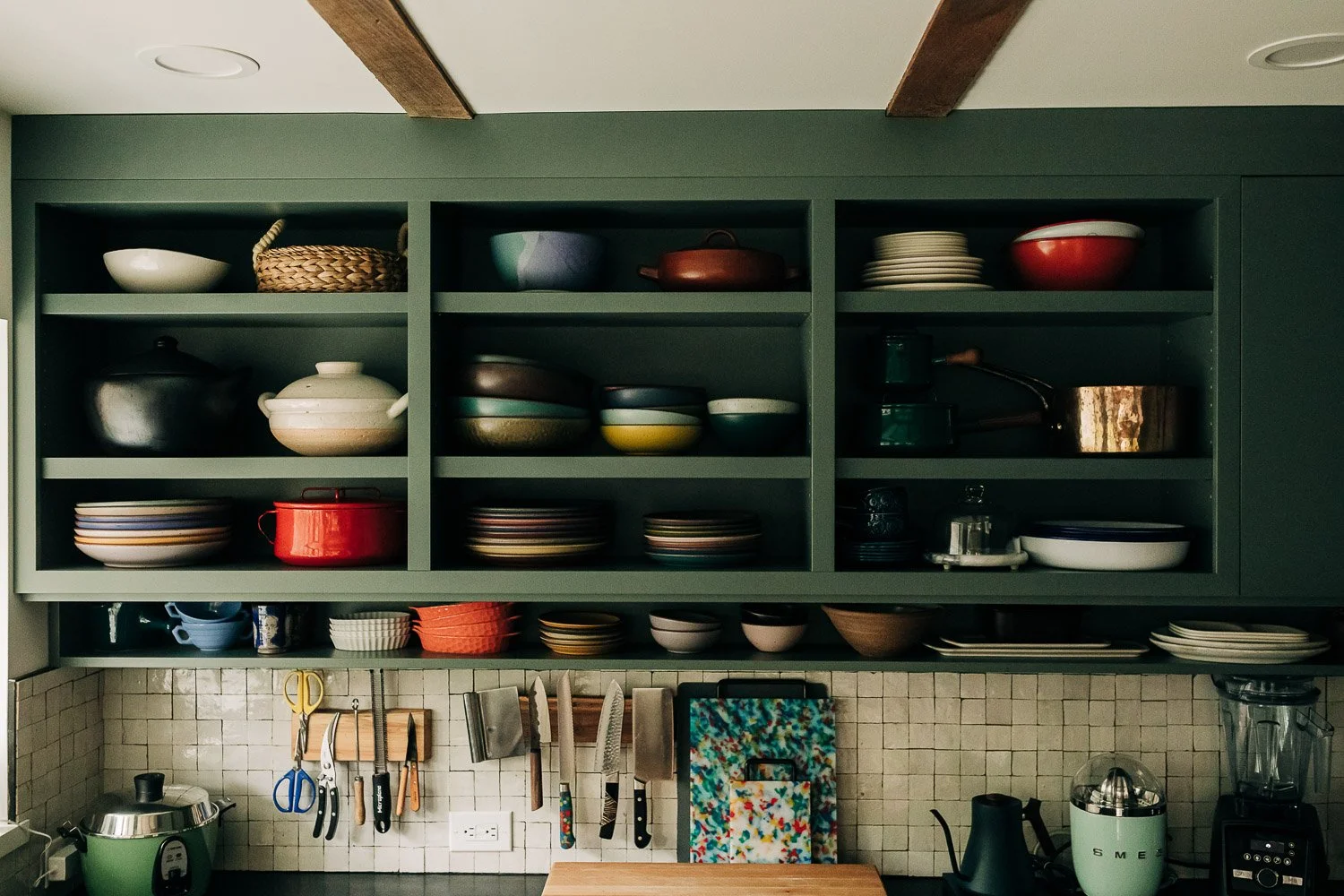 Open shelving with painted millwork cabinetry displaying East Fork Pottery from Asheville North Carolina