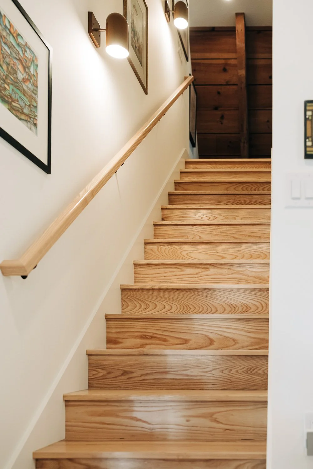 Custom wood stair system with clean modern railing detail and hardwood treads in Bat Cave North Carolina mountain home