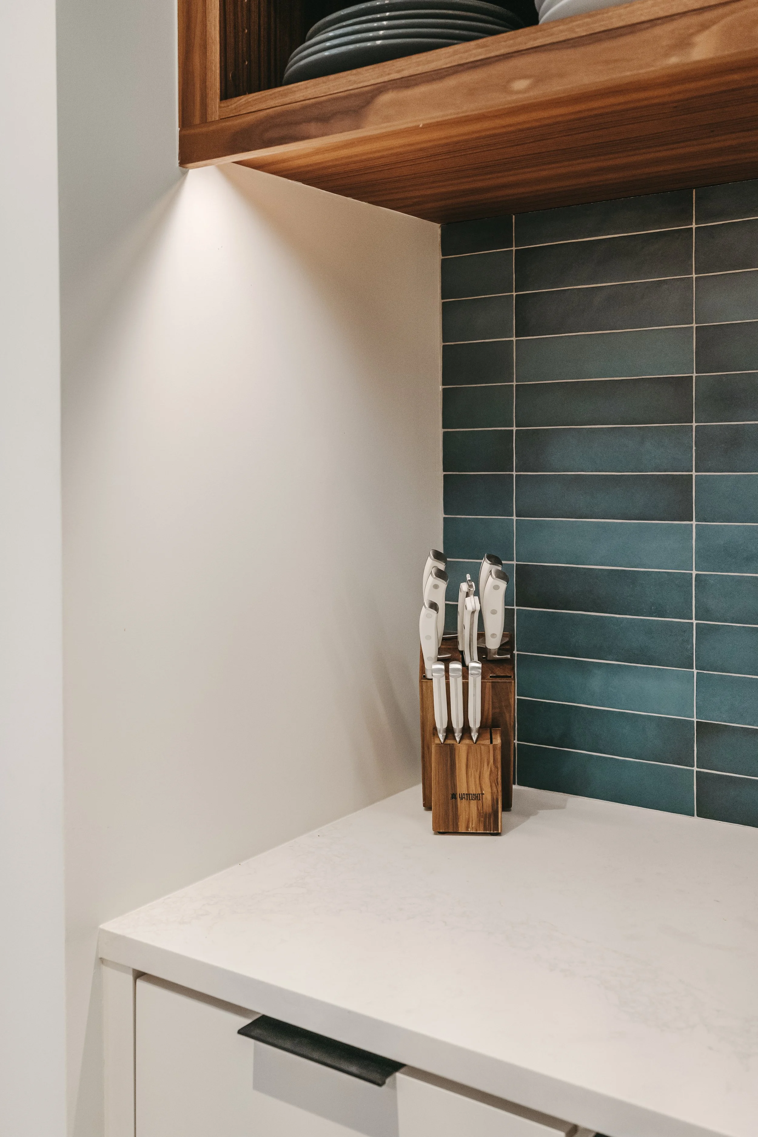 Custom woodwork by Sunnyside Millwork Open concept Two-tone kitchen with grain-matched walnut uppers, white lacquer cabinets, and integrated millwork island with quartz surface in Kernersville, North Carolina