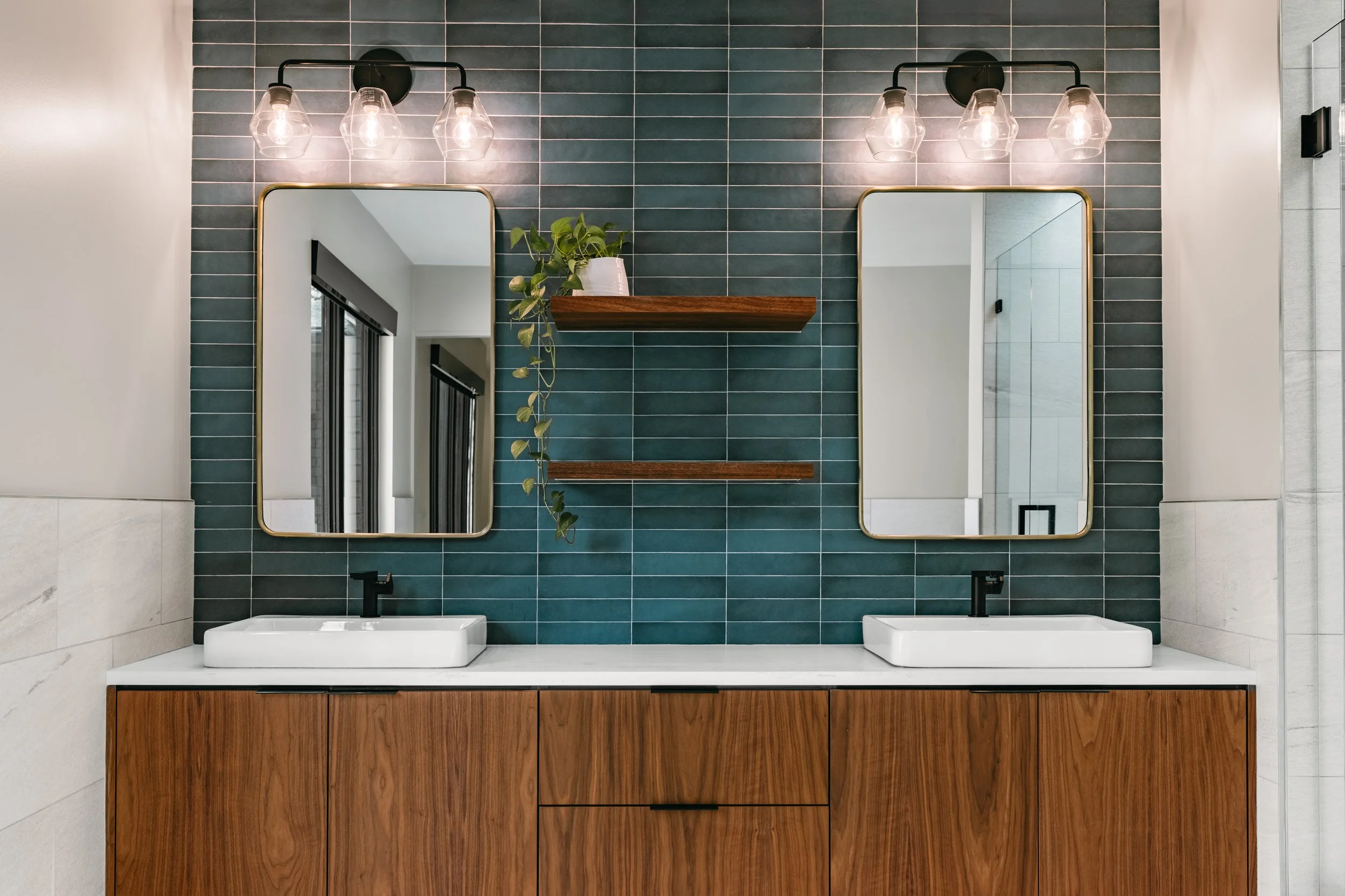 Custom woodwork by Sunnyside Millwork Floating walnut vanity with integrated lighting, quartz countertop, and custom millwork storage in modern bathroom design in Kernersville, North Carolina