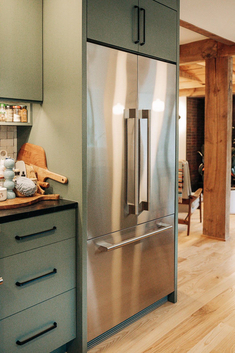 Custom kitchen millwork in mountain home in Bat Cave North Carolina near Lake Lure and Chimney Rock, featuring painted cabinetry, open shelving, and East Fork Pottery from Asheville NC