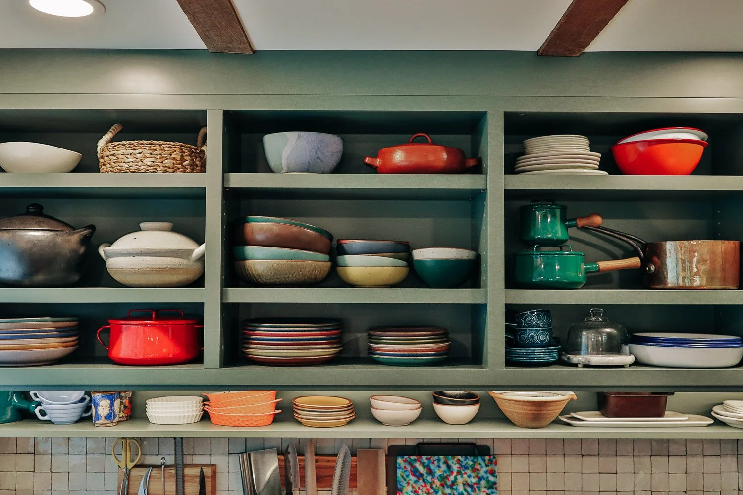 Custom kitchen millwork in mountain home in Bat Cave North Carolina near Lake Lure and Chimney Rock, featuring painted cabinetry, open shelving, and East Fork Pottery from Asheville NC