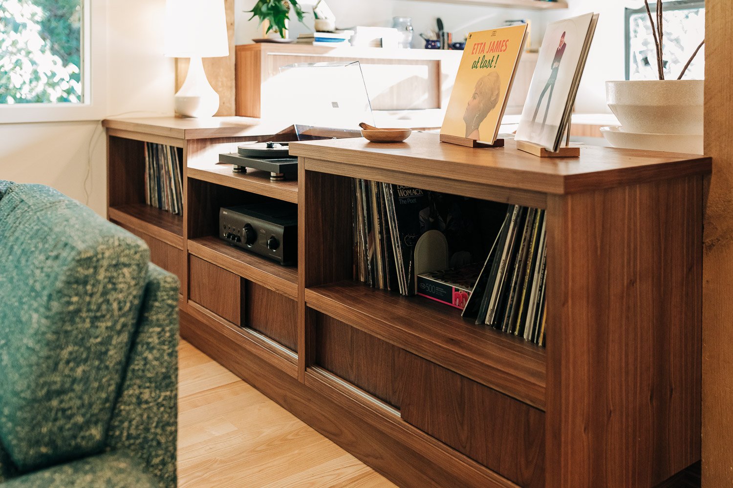 Custom black walnut record cabinet with integrated storage and display shelving in North Carolina mountain home