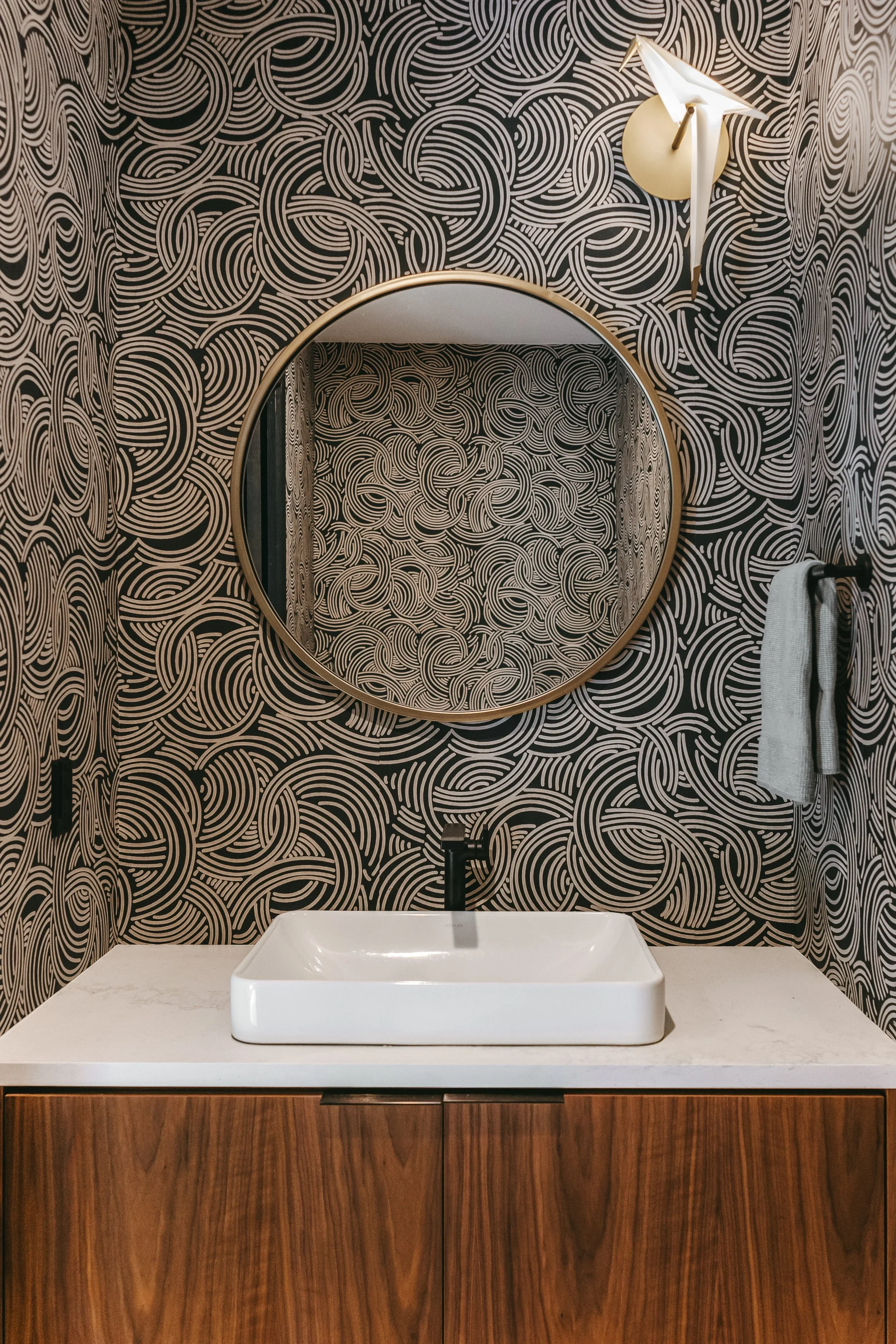 Custom black walnut vanity with grain-matched cabinetry, vessel sink, and hidden pocket door system in remodeled Kernersville North Carolina home