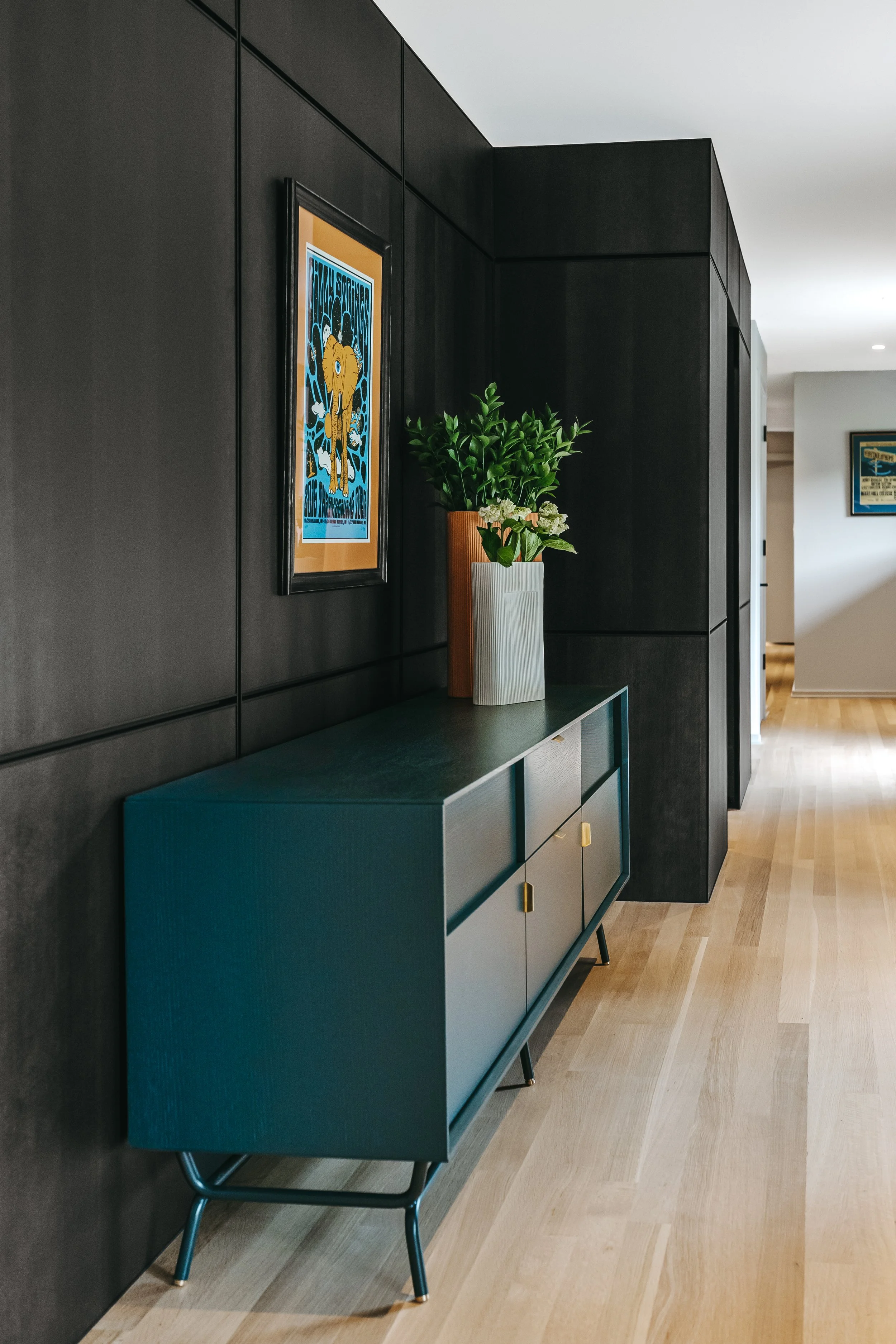 Custom woodwork by Sunnyside Millwork Black rift white oak panel wall with India ink finish and integrated flush seams custom architectural millwork detail with blue buffet sideboard furniture piece in Kernersville, North Carolina Fry Reglet aluminum