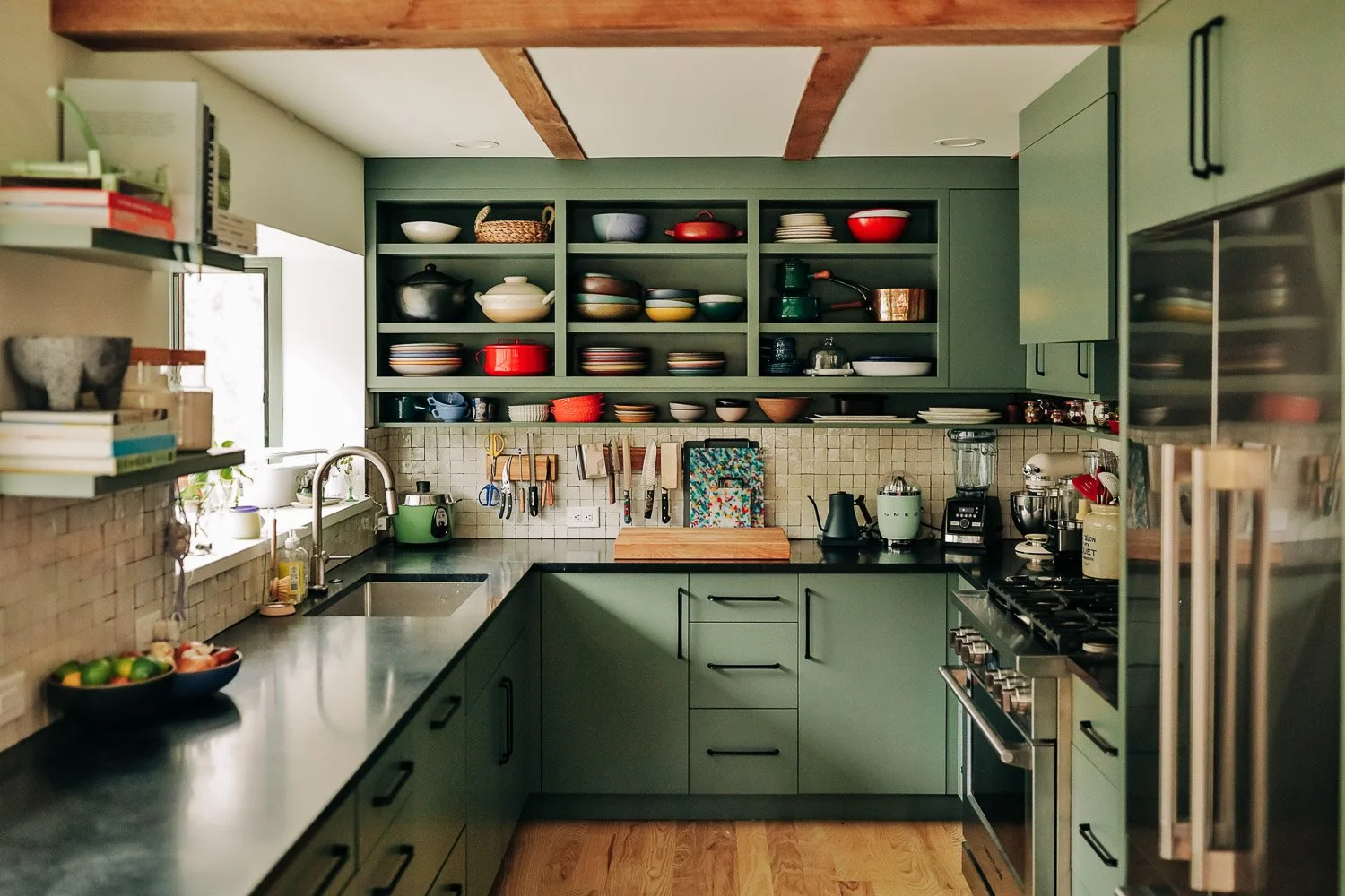 Custom kitchen millwork in mountain home in Bat Cave North Carolina near Lake Lure and Chimney Rock, featuring painted cabinetry, open shelving, and East Fork Pottery from Asheville NC